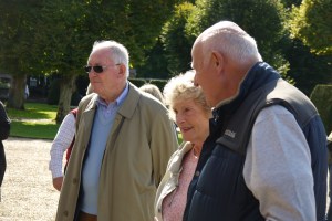 Photo of people looking at cars.